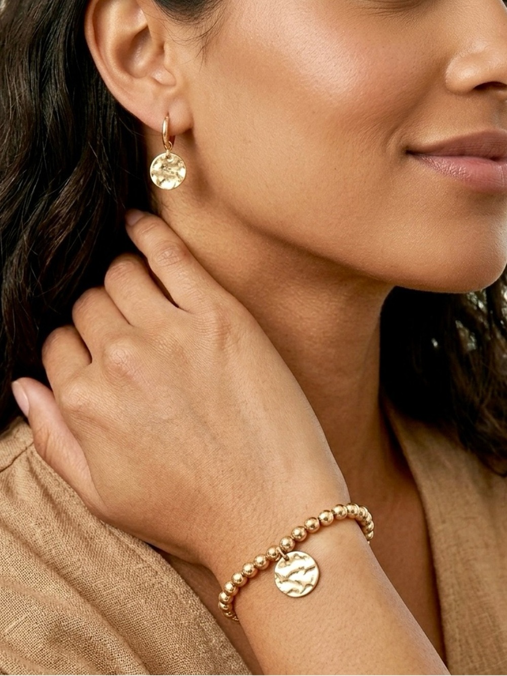 NEW. Set of 14KT gold plated hoop earrings and bracelet with golden disc charm.